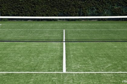 Synthetic grass for tennis Symmetrical shot of tennis net and forecourt.